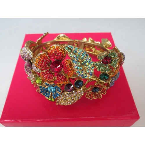 39 - A BUTLER AND WILSON MULTI-COLOURED FLORAL THEME HINGED BANGLE, together with a Butler and Wilson flo... 