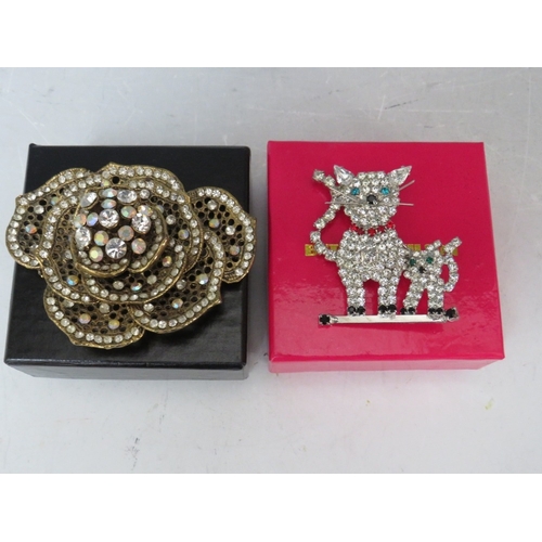 47 - FOUR BUTLER AND WILSON BROOCHES, to include a cat sat in a moon -  L 12 cm and a brushed gilt charm ... 