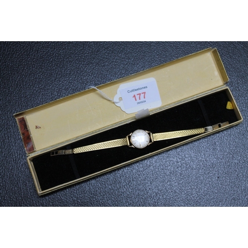 177 - A 9 CARAT GOLD LADIES OMEGA WRIST WATCH, on replacement plated strap and lacking winder, Dia 2 cm