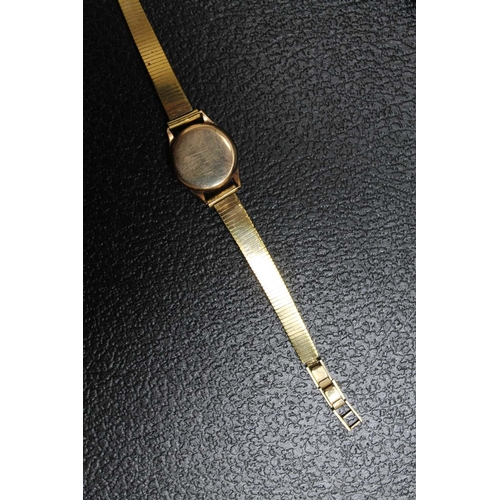 177 - A 9 CARAT GOLD LADIES OMEGA WRIST WATCH, on replacement plated strap and lacking winder, Dia 2 cm