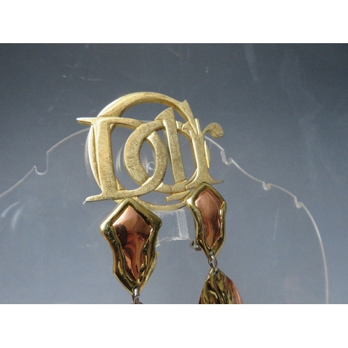 57 - A VINTAGE PARFUMS CHRISTIAN DIOR GOLDTONE BROOCH, W 6.2 cm, together with a pair of hand crafted cop... 