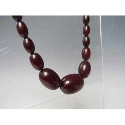 60 - A CHERRY RED FATURAN AMBER GRADUATED OVAL BEAD NECKLACE, approx L 54 cm, approx weight 39 g