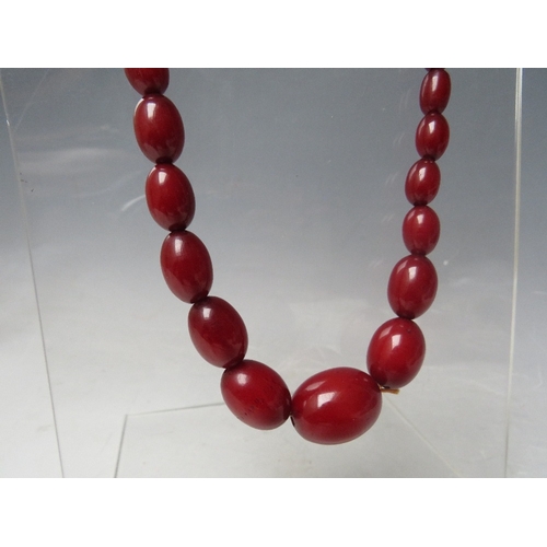 61 - A CHERRY RED FATURAN AMBER GRADUATED OVAL BEAD NECKLACE, approx L 59 cm, approx weight 40 g