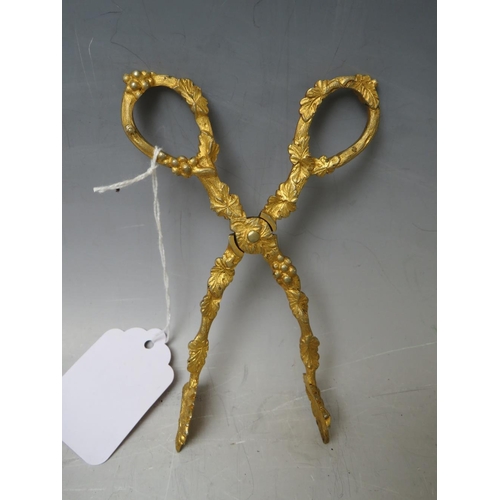 133 - A PAIR OF 19TH CENTURY GILT SUGAR NIPS, together with a silver plated pair of grape scissors (2)