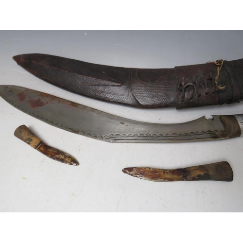 220 - A GURKHA KUKRI KNIFE IN LEATHER COVERED SHEATH, and with two smaller knives, blade L 41 cm, overall ... 