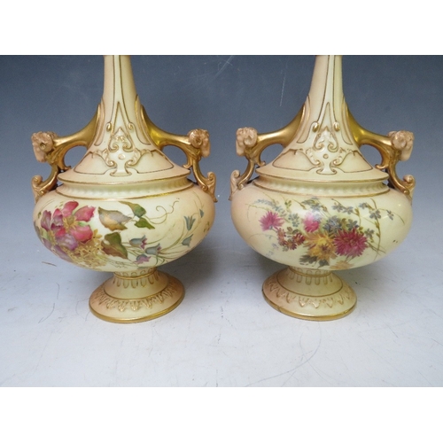 197 - A PAIR OF  ROYAL WORCESTER BLUSH IVORY TWIN HANDLED VASES, decorated with flowers and rams head deta... 
