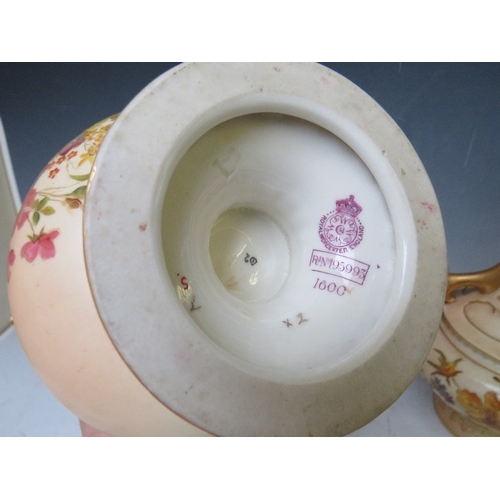 197 - A PAIR OF  ROYAL WORCESTER BLUSH IVORY TWIN HANDLED VASES, decorated with flowers and rams head deta... 