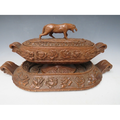 207 - A LARGE BLACK FOREST CARVED LIDDED DISH ON A CARVED BASE, the handle in the shape if a wild animal, ... 