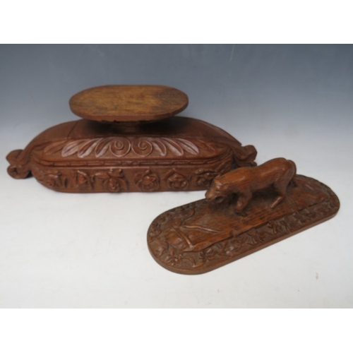 207 - A LARGE BLACK FOREST CARVED LIDDED DISH ON A CARVED BASE, the handle in the shape if a wild animal, ... 