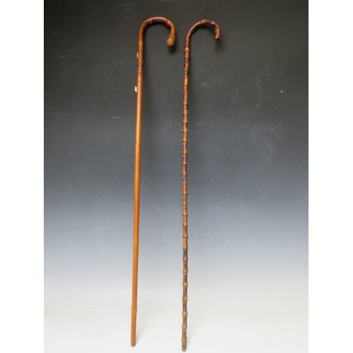 232 - A VINTAGE EASTERN CARVED MALACCA WALKING STICK, L 88 cm, together with another walking stick (2)