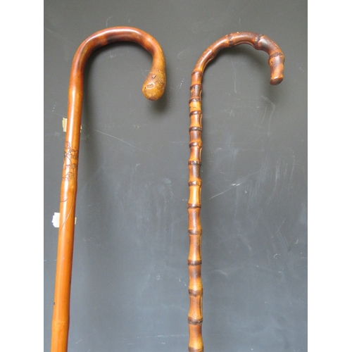 232 - A VINTAGE EASTERN CARVED MALACCA WALKING STICK, L 88 cm, together with another walking stick (2)