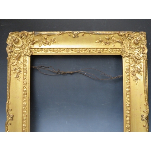 28 - A 19TH CENTURY DECORATIVE GOLD SWEPT FRAME, frame W 10 cm, rebate 53 x 45 cm