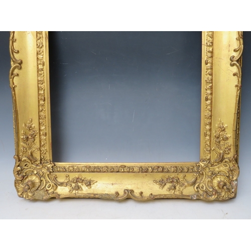 28 - A 19TH CENTURY DECORATIVE GOLD SWEPT FRAME, frame W 10 cm, rebate 53 x 45 cm