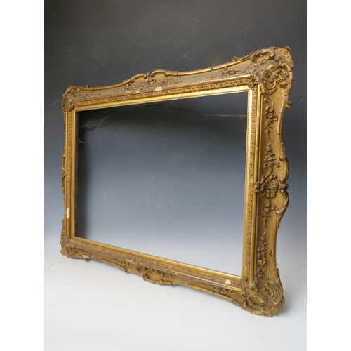 29 - A 19TH CENTURY DECORATIVE GOLD SWEPT FRAME, with gold slip, frame W 8 cm, slip rebate 45 x 60, frame... 