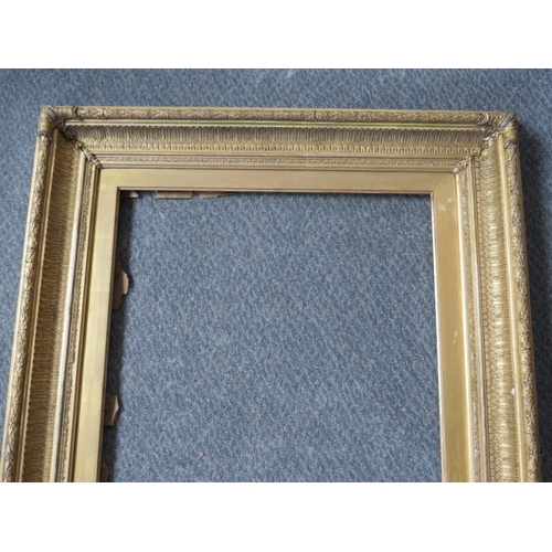 31 - A 19TH CENTURY DECORATIVE GOLD FRAME, with gold slip, frame W 9 cm, slip rebate 60 x 47 cm, frame re... 