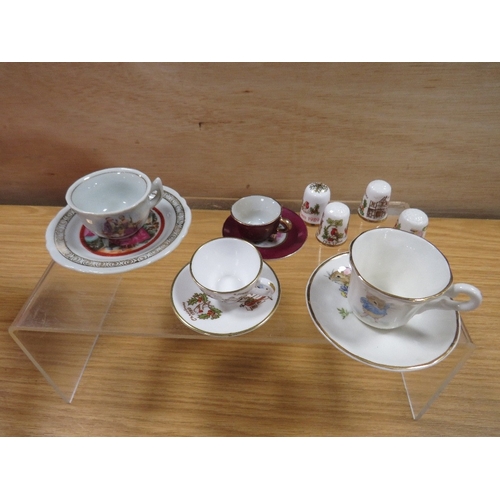 477 - A SMALL TRAY OF MINATURE CUPS AND SAUCERS