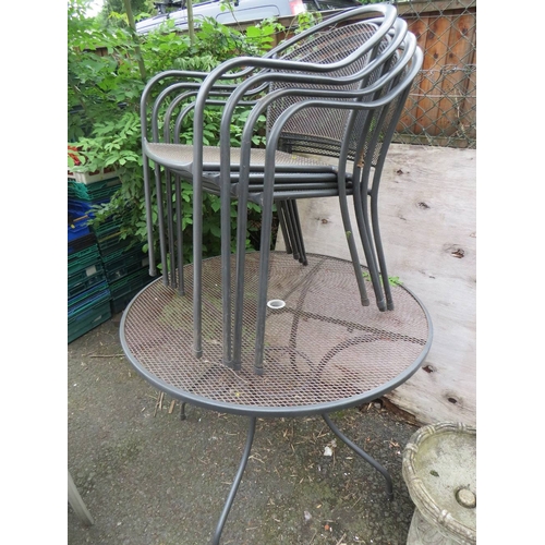 705 - A ROUND METAL FIVE PIECE GARDEN TABLE SET WITH FOUR STACKING CHAIRS