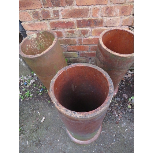 717 - THREE TERRACOTTA CHIMNEY POT PLANTERS