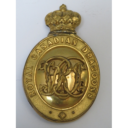 211 - A VICTORIAN ROYAL CANADIAN DRAGOONS HELMET PLATE CENTRE BADGE, with later brooch fitting and a small... 