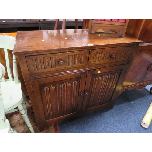 875 - AN OAK LINEN FOLD DRESSER BASE