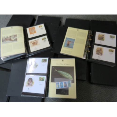 153 - TWELVE ALBUMS OF STAMPS / FIRST DAY COVERS, world wildlife 1983 to 2003, together with a bag of loos... 