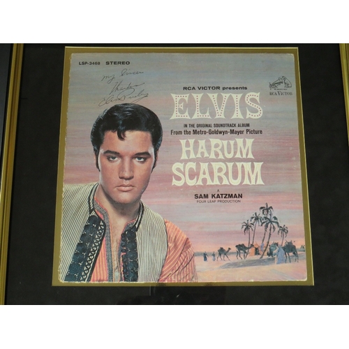 230 - A MOUNTED ELVIS PRESLEY HARUM SCARUM RCA VICTOR VINYL RECORD AND RECORD SLEEVE, signed by Elvis Pres... 