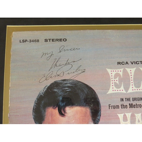 230 - A MOUNTED ELVIS PRESLEY HARUM SCARUM RCA VICTOR VINYL RECORD AND RECORD SLEEVE, signed by Elvis Pres... 