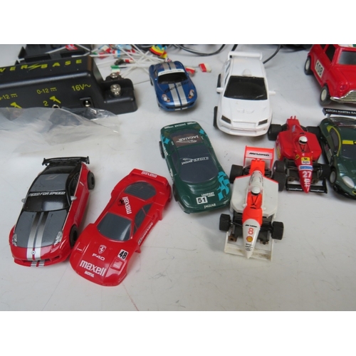 439 - A BOXED MICRO SCALEXTRIC, with track, cars, transformer and hand controls, together with a box of mi... 