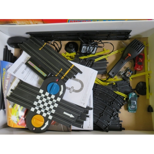 439 - A BOXED MICRO SCALEXTRIC, with track, cars, transformer and hand controls, together with a box of mi... 