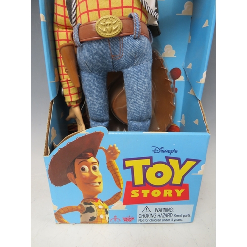 425 - A DISNEY TOY STORY PULL STRING TALKING WOODY IN ORIGINAL BOX, together with a pair of remote control... 