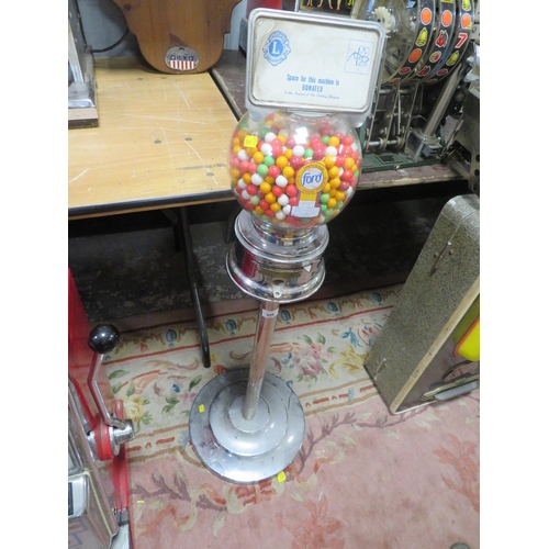 526 - A VINTAGE FORD GUMBALL MACHINE & Co VENDING MACHINE, with label panel to the top, raised on a chrome... 