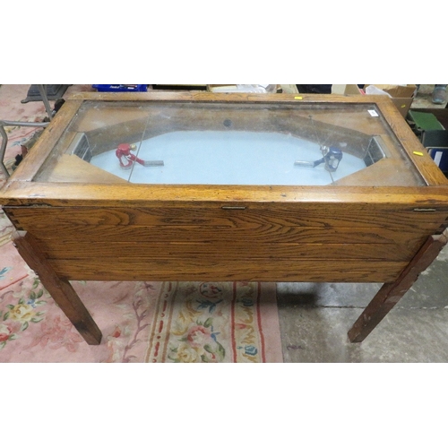 539 - A VINTAGE 'R & W' ICE HOCKEY GAME, of mainly wood construction, with glaze top, fitted with coin ope... 