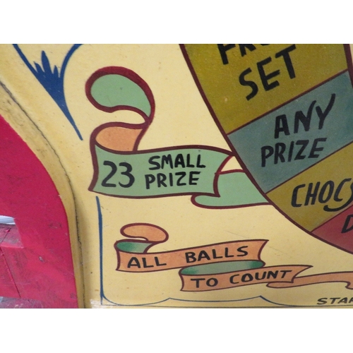 568 - 'BEAT THE CLOCK' A MID 20TH CENTURY PAINTED WOOD FAIRGROUND ROLL A BALL GAME BOARD, in red and yello... 