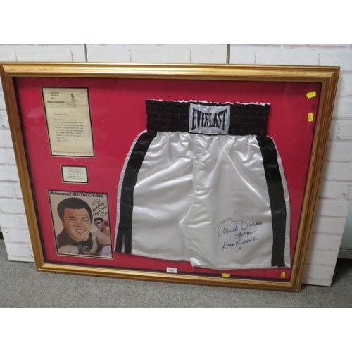 317 - A PAIR OF FRAMED BOXING SHORTS AND A PICUTRE OF MUHAMMAD ALI, both signed by trainer Angelo Dundee, ... 