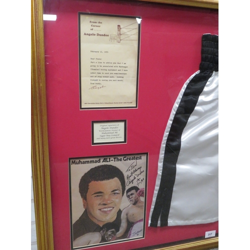 317 - A PAIR OF FRAMED BOXING SHORTS AND A PICUTRE OF MUHAMMAD ALI, both signed by trainer Angelo Dundee, ... 