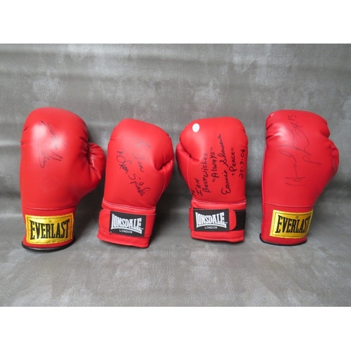 325 - FOUR SIGNED BOXING GLOVES, to include Leon Spinks, Evander Holyfield, Ernie Shavers and Thomas Hearn... 