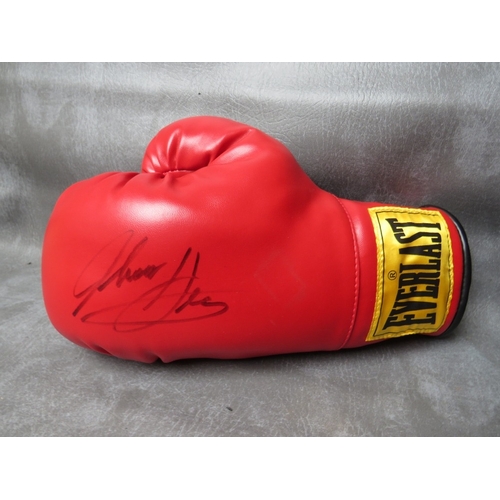 325 - FOUR SIGNED BOXING GLOVES, to include Leon Spinks, Evander Holyfield, Ernie Shavers and Thomas Hearn... 