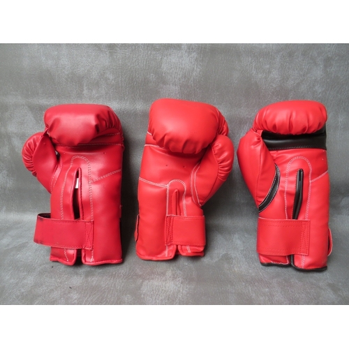 327 - THREE SIGNED BOXING GLOVES, to include Richie Woodhall, Nigel Benn and Roberto Duran