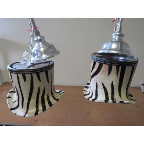 508 - A SET OF FOUR UNUSUAL DESIGNER ZEBRA PATTERN TOP HAT PENDANT LIGHTS, in chrome and faux zebra fur