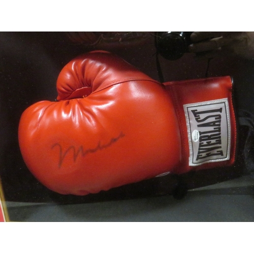 309 - A FRAMED MUHAMMAD ALI BOXING GLOVE AND HEADGUARD, both items signed