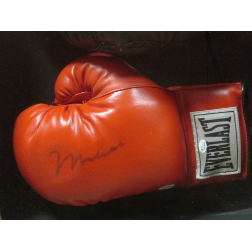 309 - A FRAMED MUHAMMAD ALI BOXING GLOVE AND HEADGUARD, both items signed