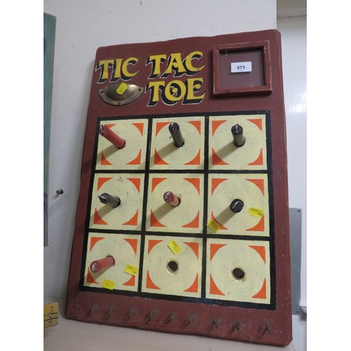 573 - A PAINTED WOOD FAIRGROUND 'TIC TAC TOE' GAME BROWN PAINTED BACK BOARD, with red and black pegs, with... 