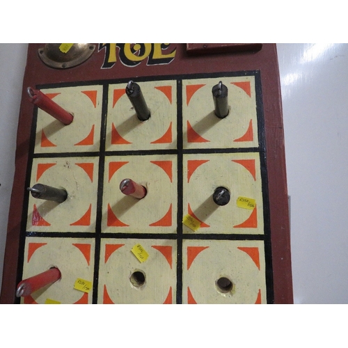 573 - A PAINTED WOOD FAIRGROUND 'TIC TAC TOE' GAME BROWN PAINTED BACK BOARD, with red and black pegs, with... 