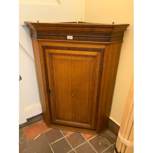 707 - A Georgian oak cross banded corner, cupboard with shell inlay to the door