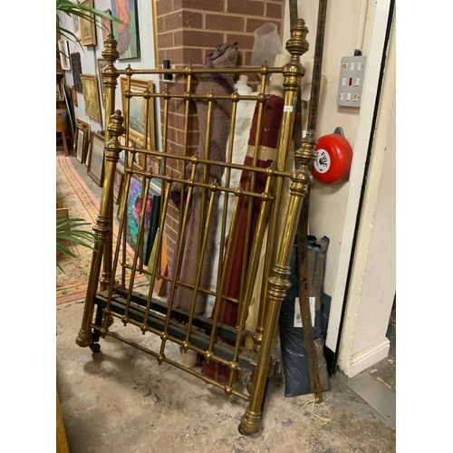 713 - A Victorian three-quarter size heavy brass bedstead with stretchers and irons