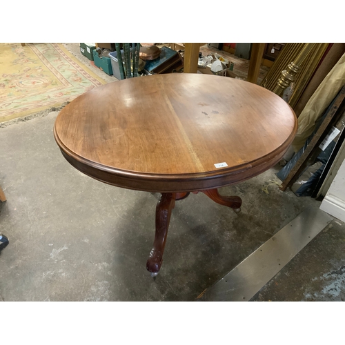 714 - An antique mahogany tilt top circular centre table with carved decoration to the legs A/F