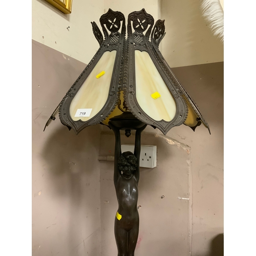 719 - A large 20th century Tiffany style table lamp model as a naked lady holding the shade standing on a ... 