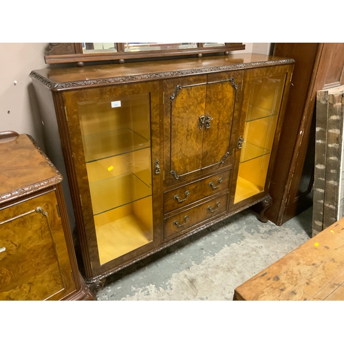 723 - A 20th century walnut display cabinet with central cupboard and drawers