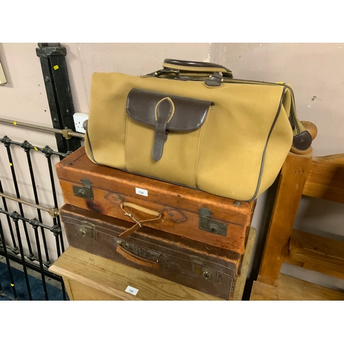 732 - Two vintage leather suitcases together with a chaps hold all