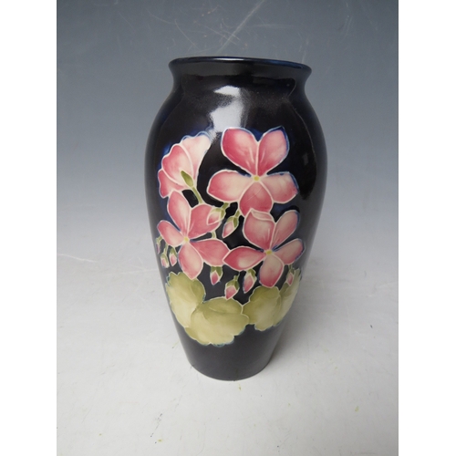 304 - A MOORCROFT FLORAL PATTERN BALUSTER VASE, H 19 cm